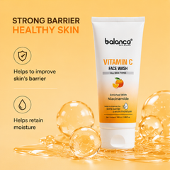 Balance Skin World Vitamin C Face Wash tube on a warm yellow-orange background with promotional text and decorative liquid droplets.